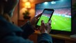 © Chrishen - Man Watching Football On Mobile Device
