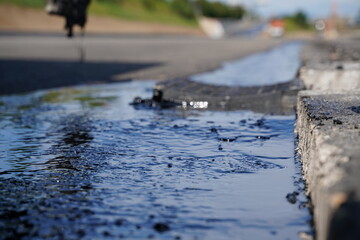 Fototapete - Low-angle detailed shot of hot bitumen coating on fresh asphalt, showcasing texture and close-up details at highway construction site