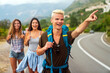 © NDABCREATIVITY - Friendship, travel, vacation, summer and people concept. Group of smiling friends with map traveling