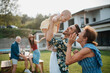 © Halfpoint - Portrait of three generations family during spring outdoor barbecue.