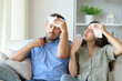 © Antonioguillem - Stressed couple sweating at home suffering heat stroke