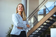 © Dragana Gordic - Confident Businesswoman Standing in Modern Office Environment With Arms Folded