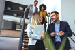 © Dragana Gordic - Professional Business Team Discussion on Office Staircase in Modern Workspace