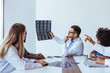© Dragana Gordic - Medical Team Analyzing Patient's Brain Scans Together in Discussion