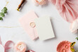 © photoguns - Stylish wedding invitation flat lay featuring pink envelope, wax seal, blank card, and elegant marble accents. Wedding stationery top view.