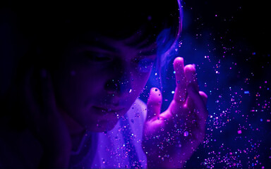 Aufkleber - A person's face and hand are illuminated with vibrant purple light in a dark space, adorned with ethereal sparkles. Looking down with a contemplative pose.