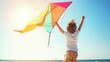 © Lion - Young caucasian male child flying colorful kite outdoors on sunny day