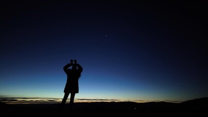 Wall Mural - amateur astronomer looking at the evening skies, observing planets, stars, moon and other celestial 
