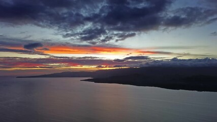 Wall Mural - aerial view of stunning sunset over calm sea waters with vibrant colors illuminating the sky, time l