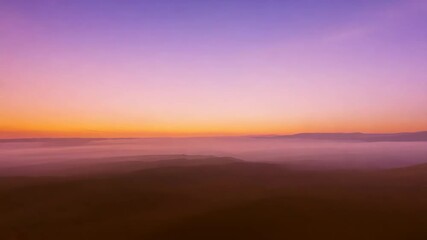 Fototapete - A beautiful sunset with a purple sky. The sky is filled with clouds and the sun is setting