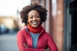 © Baba Images - Portrait of a middle age body positive African American woman in sporty clothes smiling after running on the street