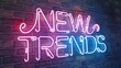 © tilialucida - Neon sign displaying the words NEW TRENDS on a brick wall