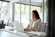 © Stock 4 You - Concentrated latin hispanic woman using computer technology for work online. Young professional it specialist latin hispanic business lady working on laptop pc sitting at desk in modern office. Wide