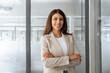 © Stock 4 You - Friendly ceo leader smiling latin hispanic, middle eastern business woman standing in office looking at camera. Portrait of middle age manager specialist entrepreneur and businesswoman at workplace