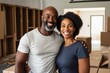 © CojanAI - Portrait of a smiling middle age African American couple in empty home after moving in