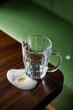 © haiqiang - there is a glass cup with a small egg on a table