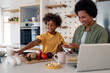 © Dorde - Joyful African American Mother And Daughter Preparing Healthy Meal Together In Modern Kitchen