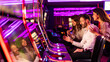 © Dragana Gordic - Group of Friends Enjoying Slot Machines in a Vibrant Casino Setting
