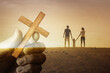 © kieferpix - A family gathered in unity before a cross, creating a heartfelt moment of faith and unity, symbolizing devotion and spiritual connection