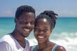 © NikoG - Smiling portrait of a young African American couple on a vacation on a tropic beach