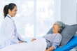 © ArLawKa - Asian female doctor consulting elderly patient at home, explaining diagnosis and treatment plan, providing health care to elderly woman, medical health concept