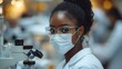 © Yana - Focused Researcher Examines Sample Through Microscope in Laboratory Setting