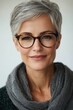 © Sittichai - Portrait of a Confident Mature Woman with Short Gray Hair and Glasses