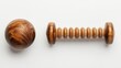 © pinporn manosri - A wooden massage ball and a wrist therapy roller arranged neatly on a white background, symbolizing wrist pain relief exercises.
