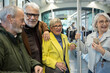 © Westend61 - Group of seniors enjoying a tram ride together