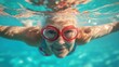 © At My Hat - Smiling senior woman with red goggles swimming underwater. Showcases active lifestyles, wellness, and enjoying life at any age.
