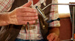 © RooM The Agency - Close-up of a Man using a machine to make his own fishing flies