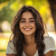 © Stefan - Portrait of a young woman with a natural look and warm smile outdoors. Soft light and warm tones create a welcoming, authentic atmosphere.
