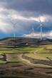 © yaqui_villegas - Landscape of Zaragoza with visible crop patterns and aligned wind turbines, capturing transition between traditional land use and clean energy