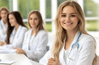 © Alina - Group of young Caucasian medical workers in white coats at lecture