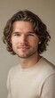 © Mai - Portrait of a Handsome Young Man with Wavy Brown Hair Wearing a Cream-Colored Sweater