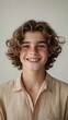 © Mai - Portrait of a Smiling Teen Boy with Curly Hair