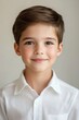 © Mai - Portrait of a Smiling Young Boy in a White Shirt