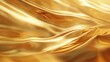 © Galib - Golden Waves  The image shows a close-up of a rippling golden fabric. The fabric is smooth and shiny, and the waves are gentle and flowing.