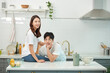 © Dialogue Frame - 'A lovely couple in white cotton tees and jeans sits the woman on the kitchen table, engaging in affectionate skinship