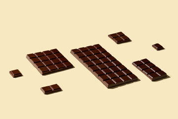 Wall Mural - composition with tasty dark chocolate bars on color background