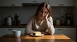 © Volha - Sad woman reflecting while sitting at kitchen table with dessert