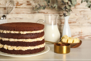 Wall Mural - tasty sponge cake and fresh ingredients on light wooden table