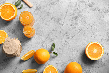 Wall Mural - jars of sweet orange jam and fruits on grey background