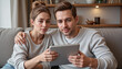© Iryna - Young couple sitting together on a couch reviewing a data protection policy on a tablet, Cyber Insurance