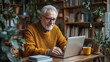 © Mykhailo - Senior Man Working on Laptop in Cozy Home Office Surrounded by Plants