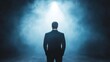 © Khuefa - A silhouette of a man in a suit standing under dramatic lighting, evoking introspection, mystery, and profound contemplation.