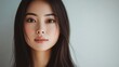 © BlackLion - Captivating close-up portrait of a young woman against a soft, neutral background during natural light