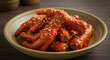 © ARDIA - Aromatic korean spicy chicken feet dish garnished with toasted sesame seeds