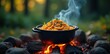 © sawaratch - A bubbling pot of noodles atop a campfire, smoke rising, food, ingredients