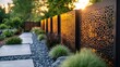 © huhu - Modern metal fence with laser cut design in garden path.